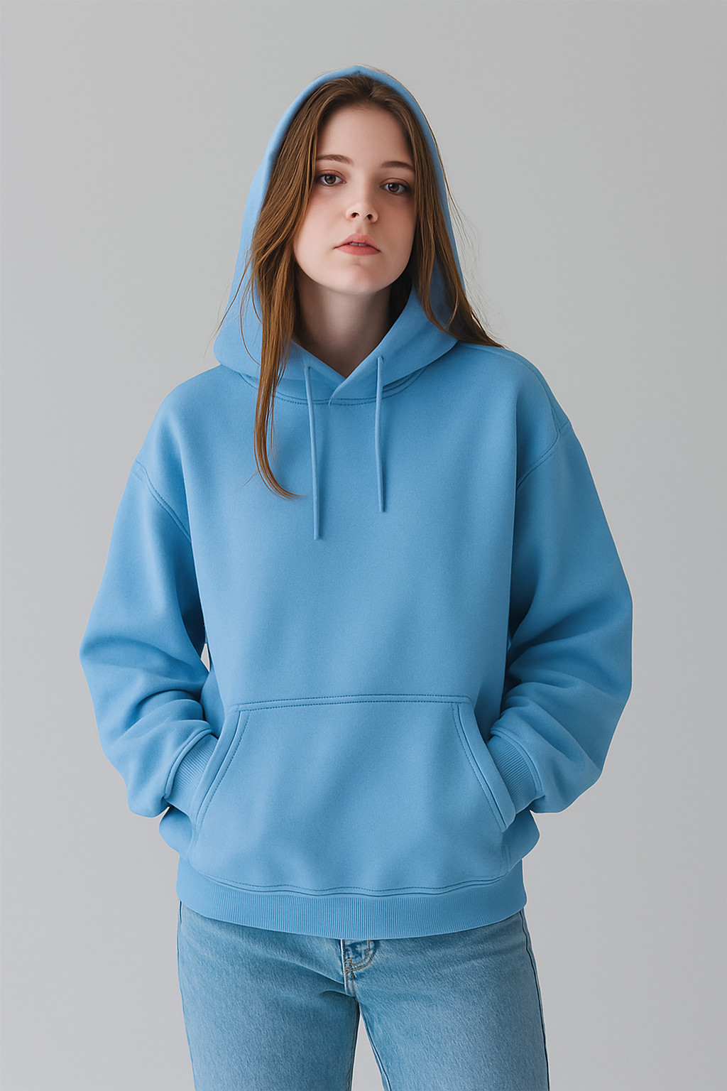 Person wearing a SKY blue hoodie on a gray background