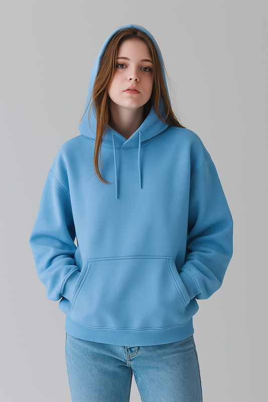 Person wearing a SKY blue hoodie on a gray background