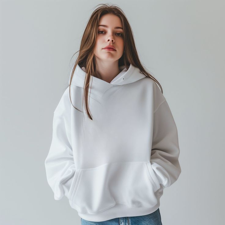 Person wearing a white hoodie against a plain background